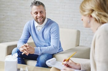 Happy client talking to therapist