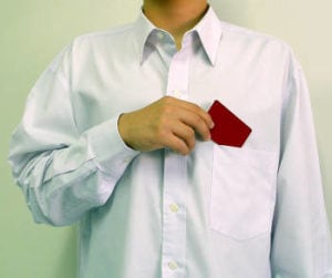 Main putting a card in his shirt pocket