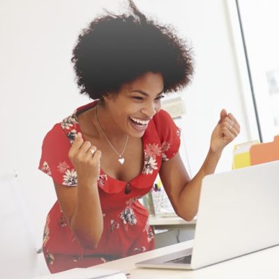 Excited Woman Working At Desk In Design Studio