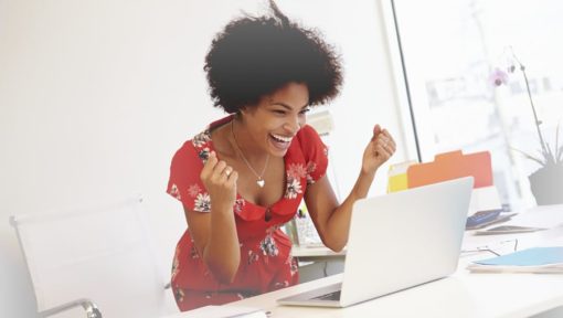 Excited Woman Working At Desk In Design Studio