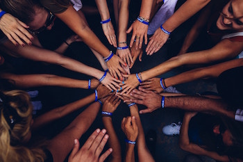 Group of people putting their hands in