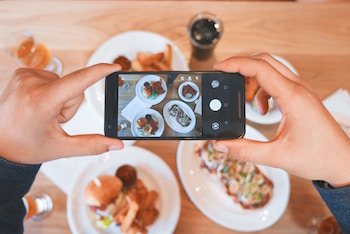 A picture of a person taking a picture of food