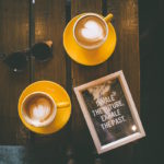 Latte art and a sign that reads, "Inhale the future and exhale the past"