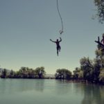 Man jumping into a lake